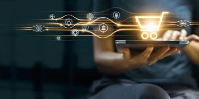 Online shopping and payment, Man using tablet with shopping cart icon, Digital marketing, Banking and finance on dark blue background.